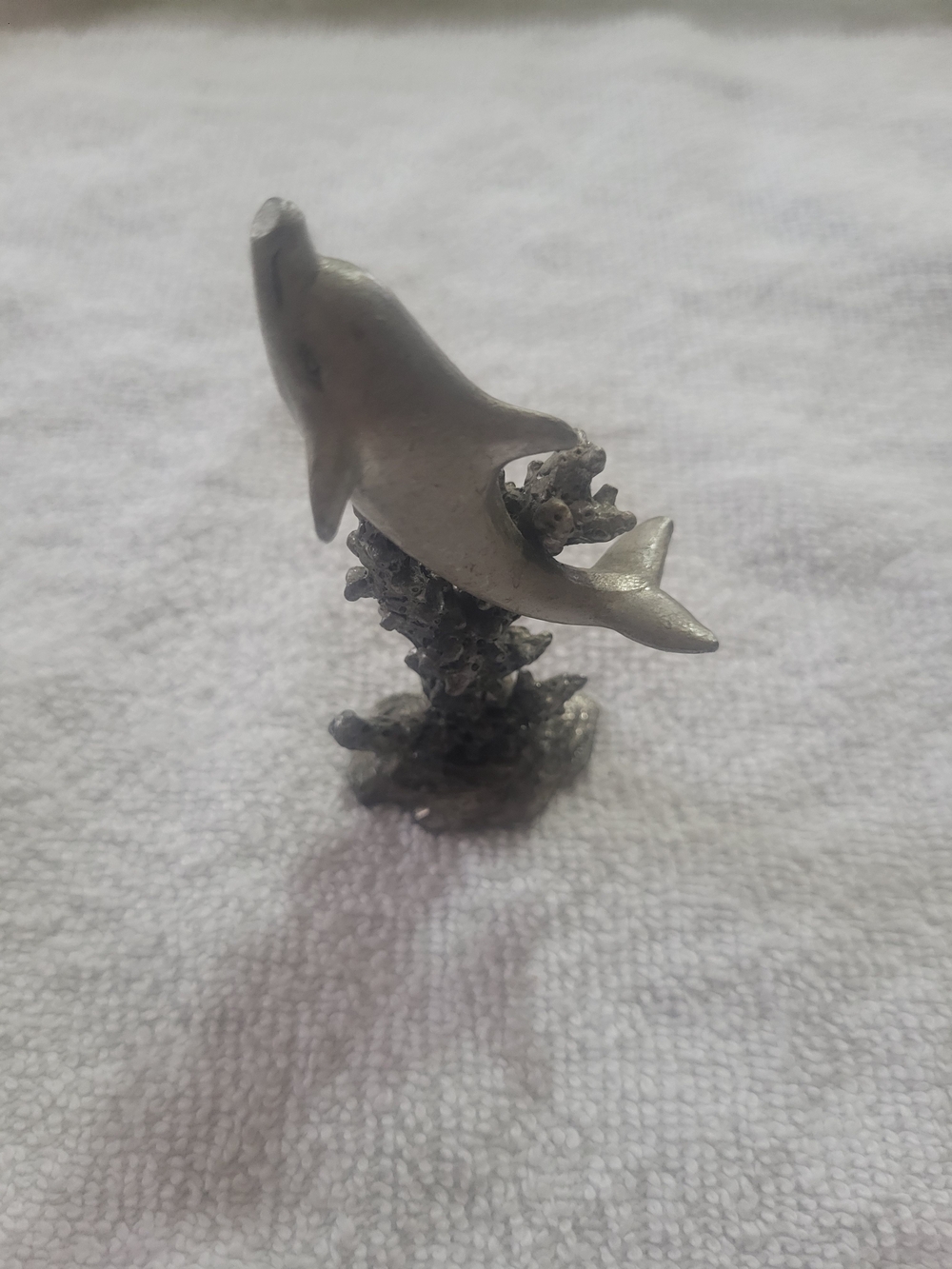 Vintage fine pewter dolphin swimming on a coral reef base figurine.